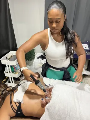 Maya Sharpe using a cupping pump on a client's back